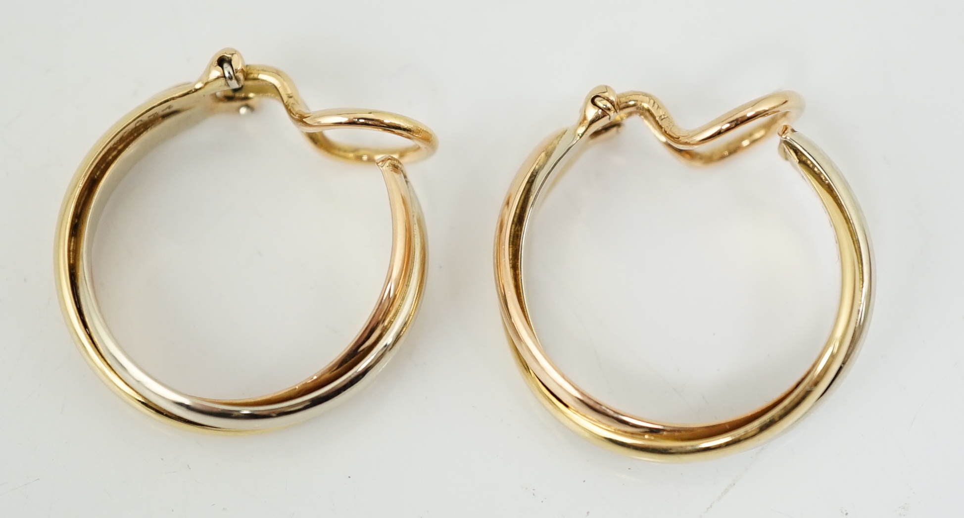 A pair of French Cartier three colour 18ct gold interwoven hoop ear clips